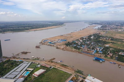 High angle view of buildings and sea against sky