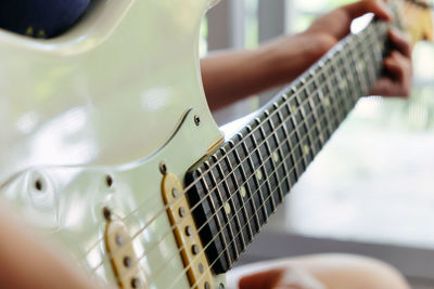 Close-up of hand playing guitar