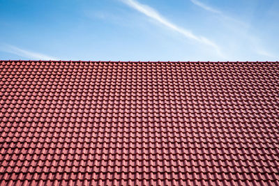 Red tiles roof on blue sky