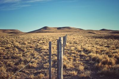 Scenic view of arid landscape against clear sky