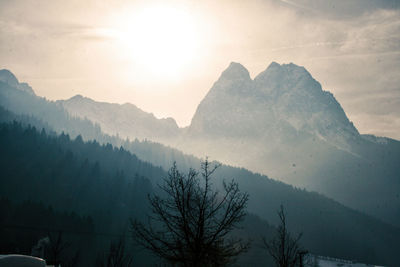 Scenic view of mountains against sky at sunset