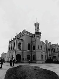 People walking on street against building in city