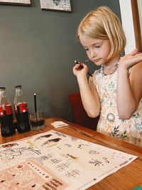 High angle view of cute girl drawing on table