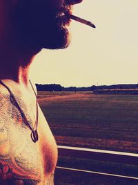 Silhouette of woman standing on tree trunk