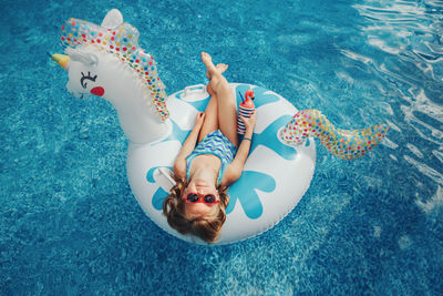 High angle view of boy swimming in pool