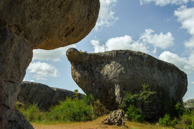 Rock formations on landscape against sky