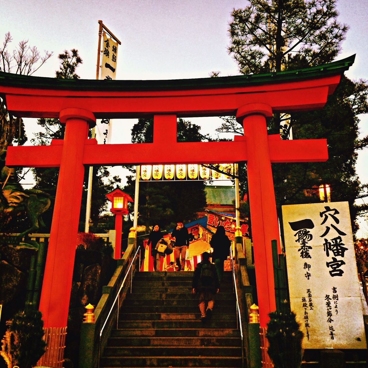 built structure, architecture, tree, building exterior, lifestyles, railing, red, leisure activity, steps, wood - material, person, clear sky, men, tradition, religion, sky, culture, temple - building, low angle view