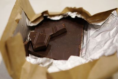 Close-up of chocolate bar in wrapper on table