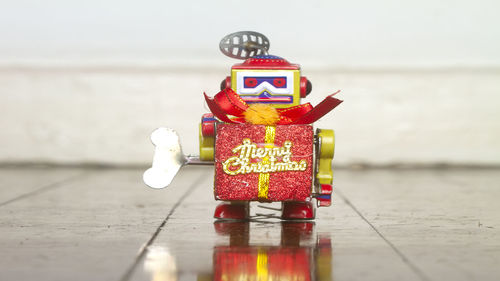 Close-up of toys on table against sea