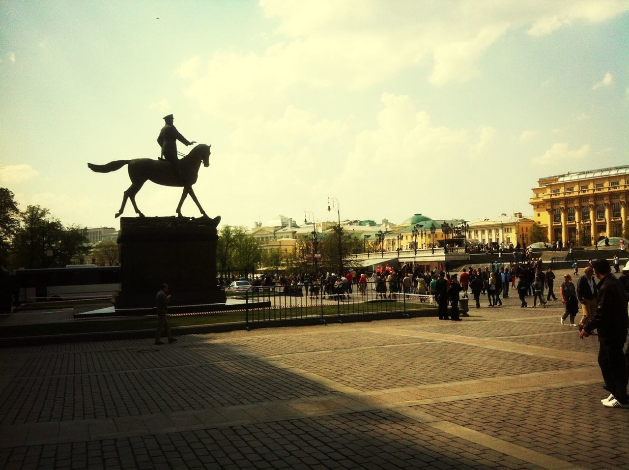 building exterior, architecture, statue, built structure, sky, sculpture, art and craft, human representation, art, cloud - sky, city, men, creativity, animal representation, town square, street, cloud, city life