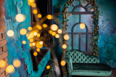 Room decorated to christmas celebration in blue luxury colors with light.