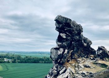 View of rock formation on landscape against sky