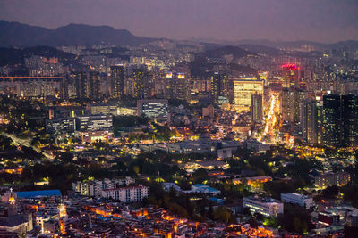 High angle view of illuminated buildings in city at night