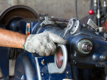 Close-up of mechanic repairing car
