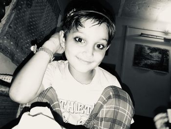 Portrait of smiling boy sitting at home