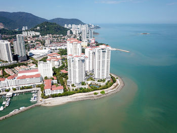 High angle view of sea and buildings against sky