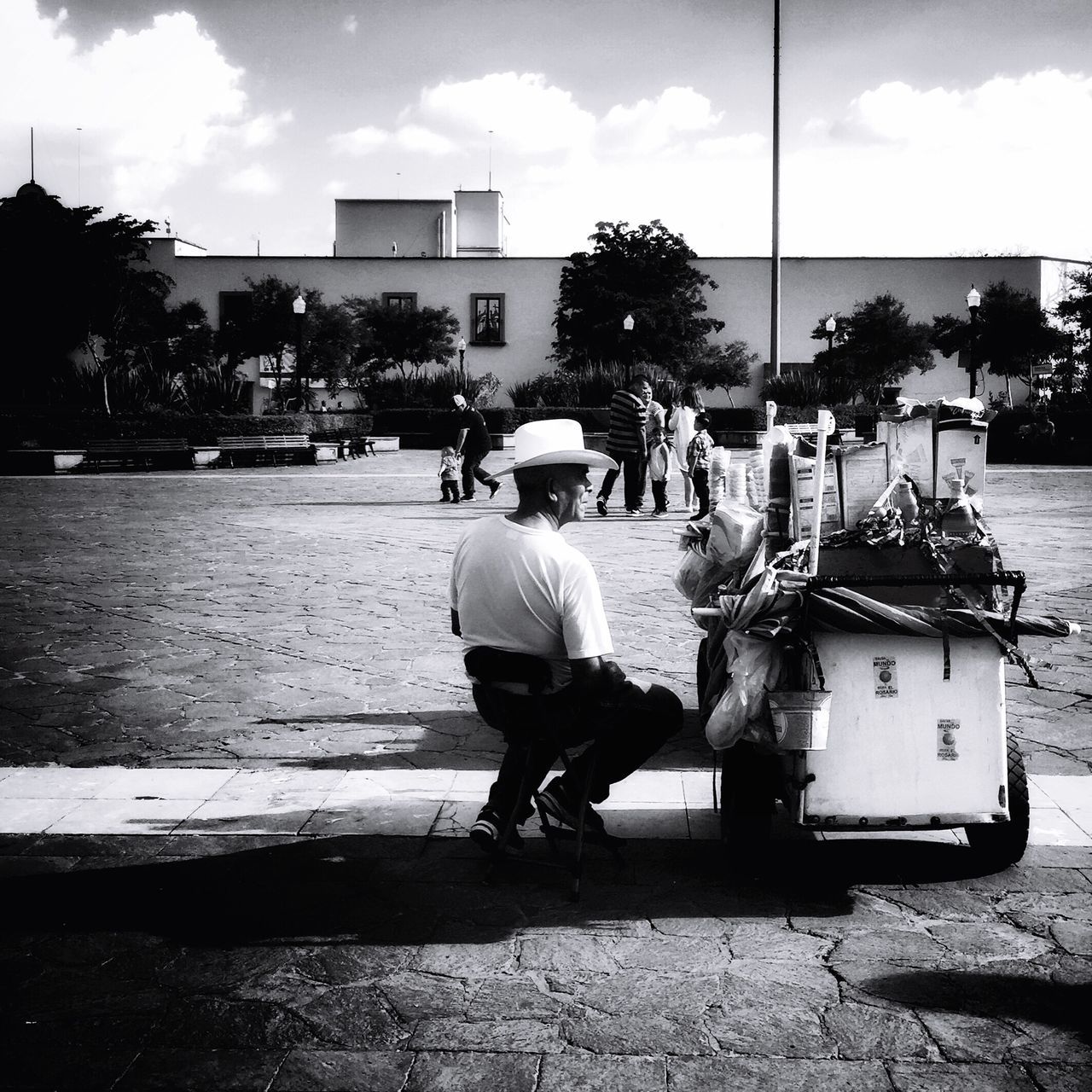 full length, sitting, bench, casual clothing, road, street, relaxation, cloud, day, solitude, sky, outdoors, young adult