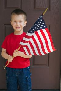 Portrait of boy holding american flag