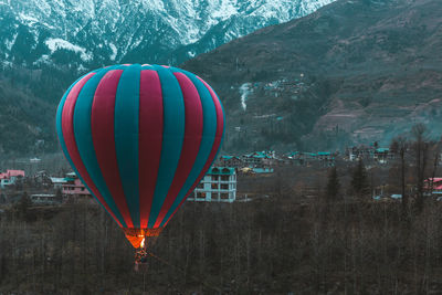 Hot air balloons flying over mountain