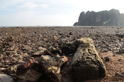 Rocks by sea against sky