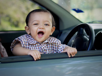 Portrait of smiling girl in car