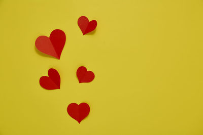 Close-up of heart shape against yellow background