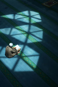 High angle view of man sitting on leaf