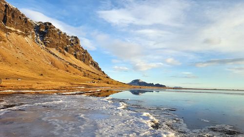 Scenic view of lake against sky during winter