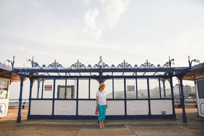 Woman standing on eastbourne pier against sky