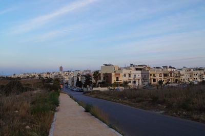 Road in city against sky