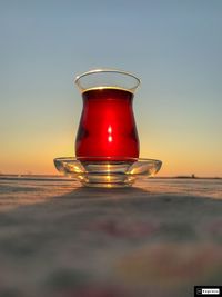 Close-up of glass of water on beach