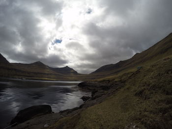 Scenic view of mountains against cloudy sky