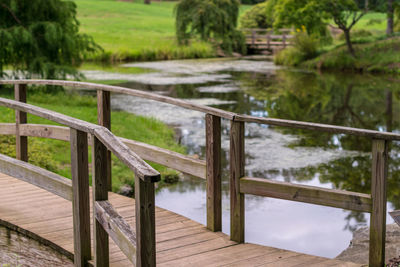 Wooden footbridge over footpath