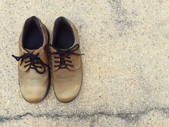 High angle view of shoes on footpath