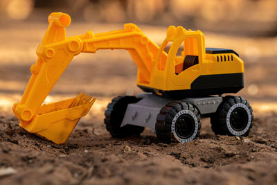 Close-up of yellow toy car on road