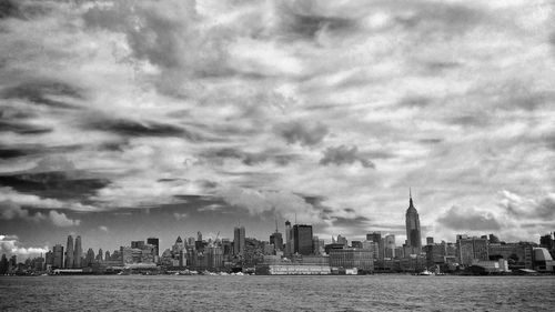 City skyline against cloudy sky