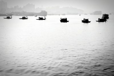 Boats in sea against sky