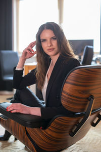 Portrait of smiling woman sitting on chair