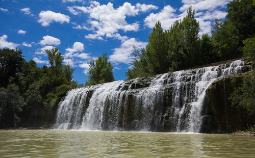 Scenic view of waterfall in forest against sky, cascata del sasso in the marche region italy