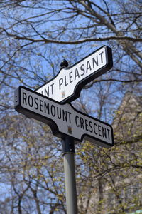 Low angle view of road sign against sky