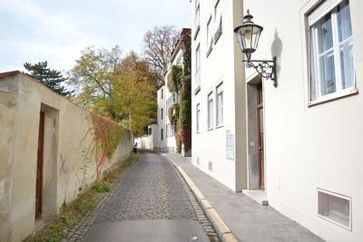 Road amidst buildings against sky