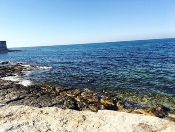 Scenic view of sea against clear blue sky