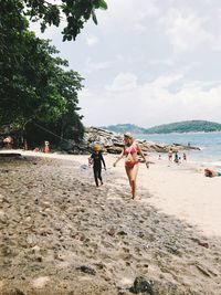 Rear view of people on beach
