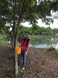 Full length of woman watering trees