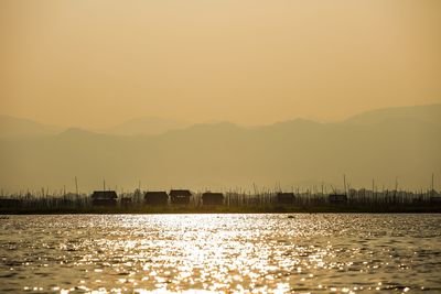 Scenic view of silhouette mountains against clear sky during sunset