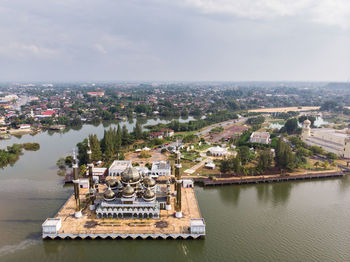 High angle view of crystal mosque by river 