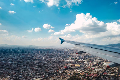 Cropped image of airplane wing against sky