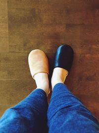 Low section of person standing on hardwood floor