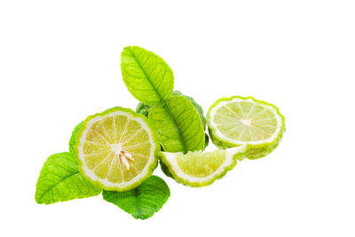 Close-up of lemon slice over white background