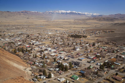 High angle view of townscape against snowcapped mountains